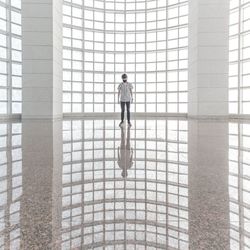 Woman walking in corridor of building