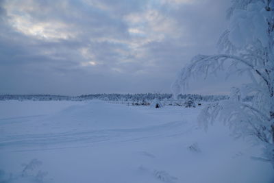 Snow covered land against sky