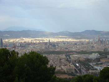 High angle view of townscape and mountains against sky