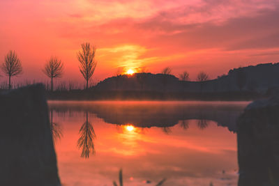 Scenic view of lake against romantic sky at sunset
