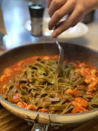 Midsection of person preparing food in kitchen