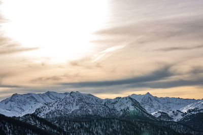 Scenic view of snowcapped mountains against sky during sunset