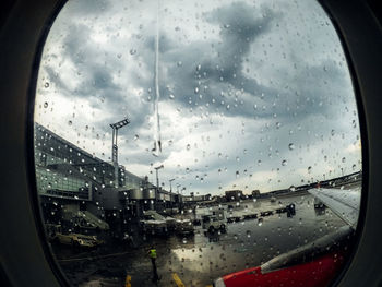 City seen through wet window during rainy season