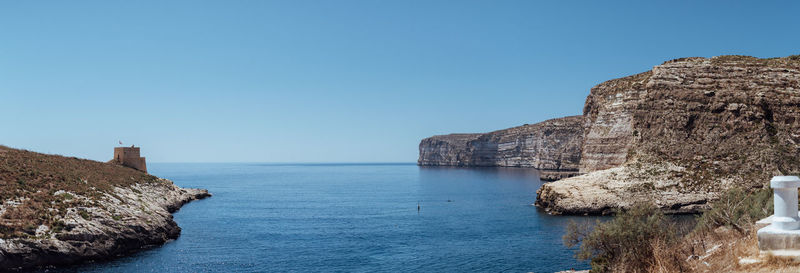 Scenic view of sea against clear blue sky