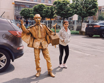 Portrait of young woman standing on street in city