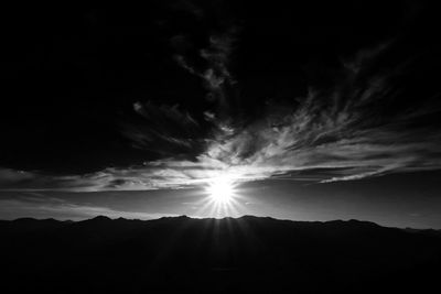 Scenic view of mountains against cloudy sky