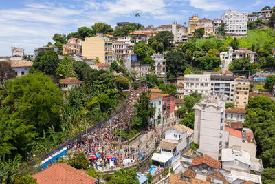 High angle view of crowd on street amidst buildings in town