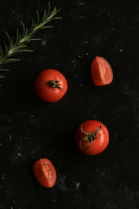 High angle view of orange berries on black background