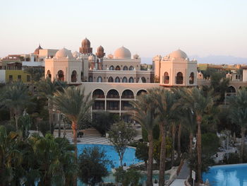 Buildings by swimming pool against sky