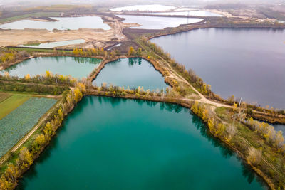 High angle view of lake by trees against sky