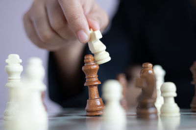 Close-up of hand of chess pieces
