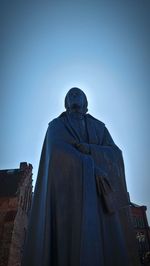 Low angle view of statue against clear blue sky