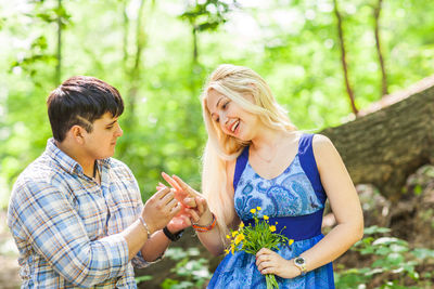 Young couple holding flowers