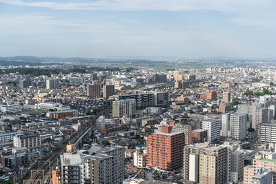 High angle view of modern buildings in city against sky