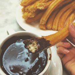Cropped image of person having churro