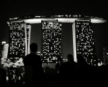 People in illuminated city at night