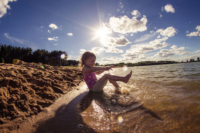 Full length of woman on beach against sky