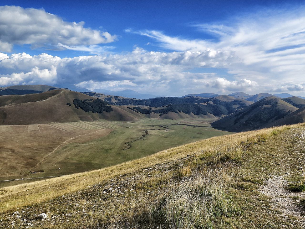 SCENIC VIEW OF MOUNTAINS AGAINST CLOUDY SKY