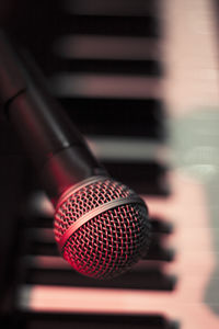 Microphone over piano keys in dim light. no people