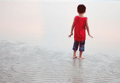 Full length of boy standing on beach