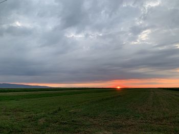 Scenic view of field against sky during sunset