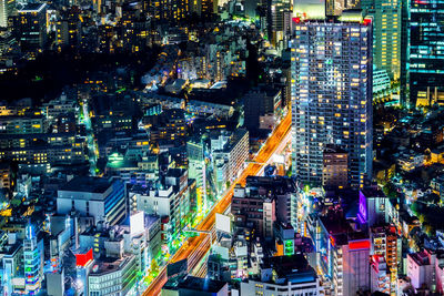 High angle view of illuminated city street and buildings at night