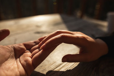 Cropped image of couple holding hands