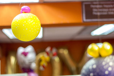 Close-up of yellow balloons hanging
