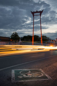 Light trails on street against sky in city