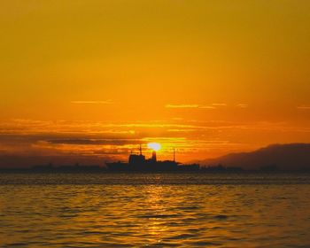 Scenic view of sea against orange sky