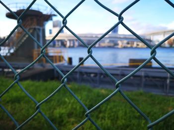 Close-up of chainlink fence against sky