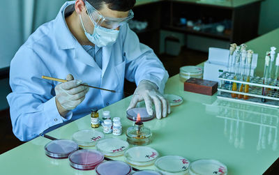 Midsection of scientist working in laboratory