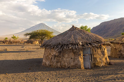 Built structure on mountain against cloudy sky