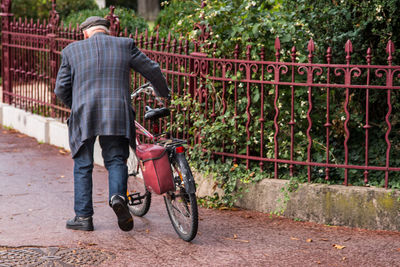 Man walking with bicycle