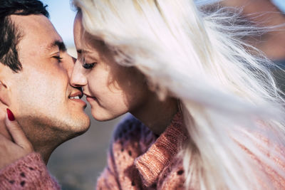 Close-up of couple kissing outdoors