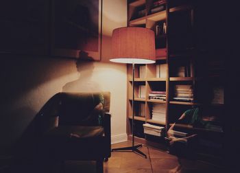 Rear view of woman sitting on floor at home