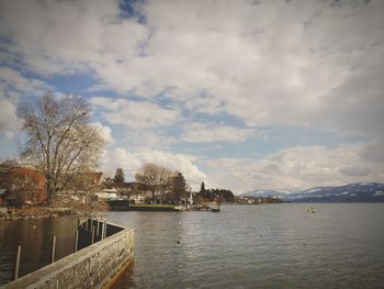 Scenic view of lake against cloudy sky