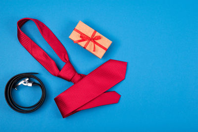 High angle view of paper on table against blue background