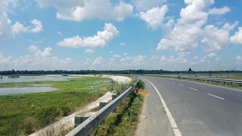 Road by landscape against sky