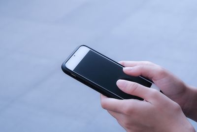 Close-up of hand holding mobile phone