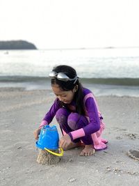 Portrait of young woman wearing swimming suit at the beach