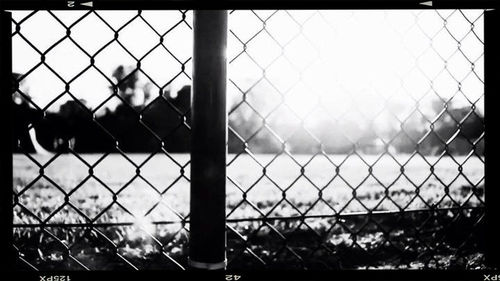 Chainlink fence seen through chainlink fence