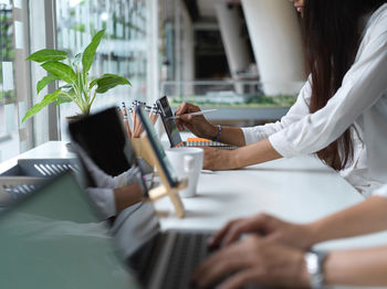 Midsection of businesswoman working in office