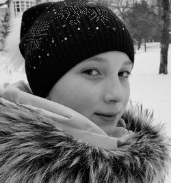 Close-up portrait of happy girl in snow