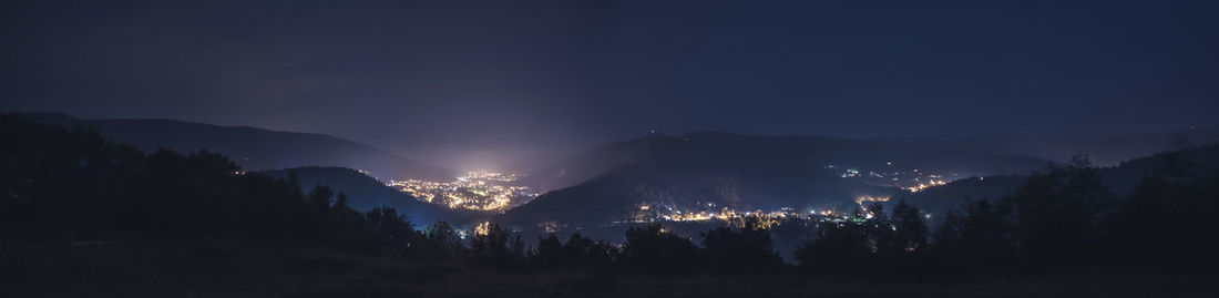 Scenic view of mountains against sky at night