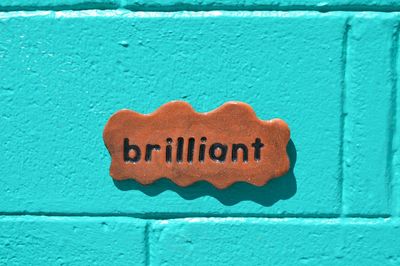 Close-up of text on brick wall