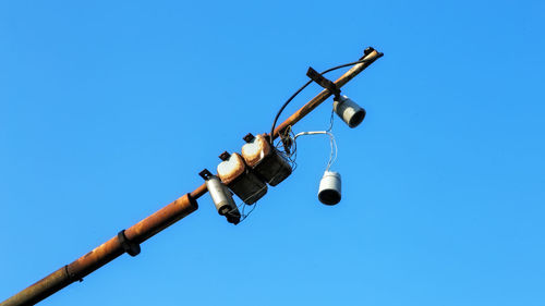 Low angle view of lamp against clear blue sky