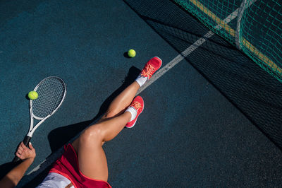 Low section of woman playing tennis