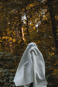 Low section of person on snow covered land during autumn