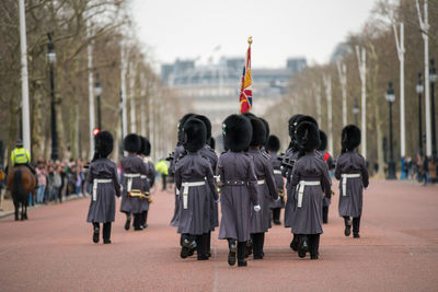 Royal guards marching at the changing of the guard ceremony across buckingham palace